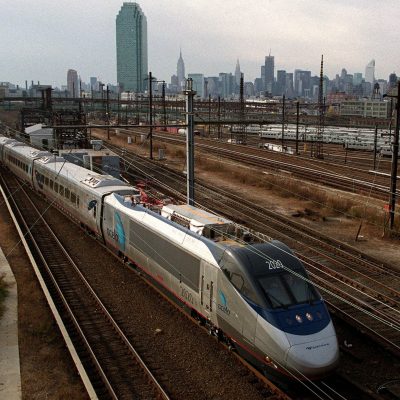 NEW YORK, UNITED STATES:  Amtrak's new Acela Express train is seen against the Manhattan skyline as it heads to Boston, 16 November 2000. The train rode from Washington DC to New York to Boston, with regular service expected to begin 11 December. The Acela Express is the first high-speed rail service in North America, moving across the Northeast at a top speed of 150 mph. (FILM) AFP PHOTO Doug KANTER (Photo credit should read DOUG KANTER/AFP/Getty Images)